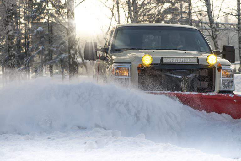 Snow plow doing snow removal after a blizzard