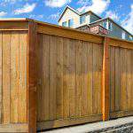 House backyard new wood fence with gate door in suburban residential neighborhood